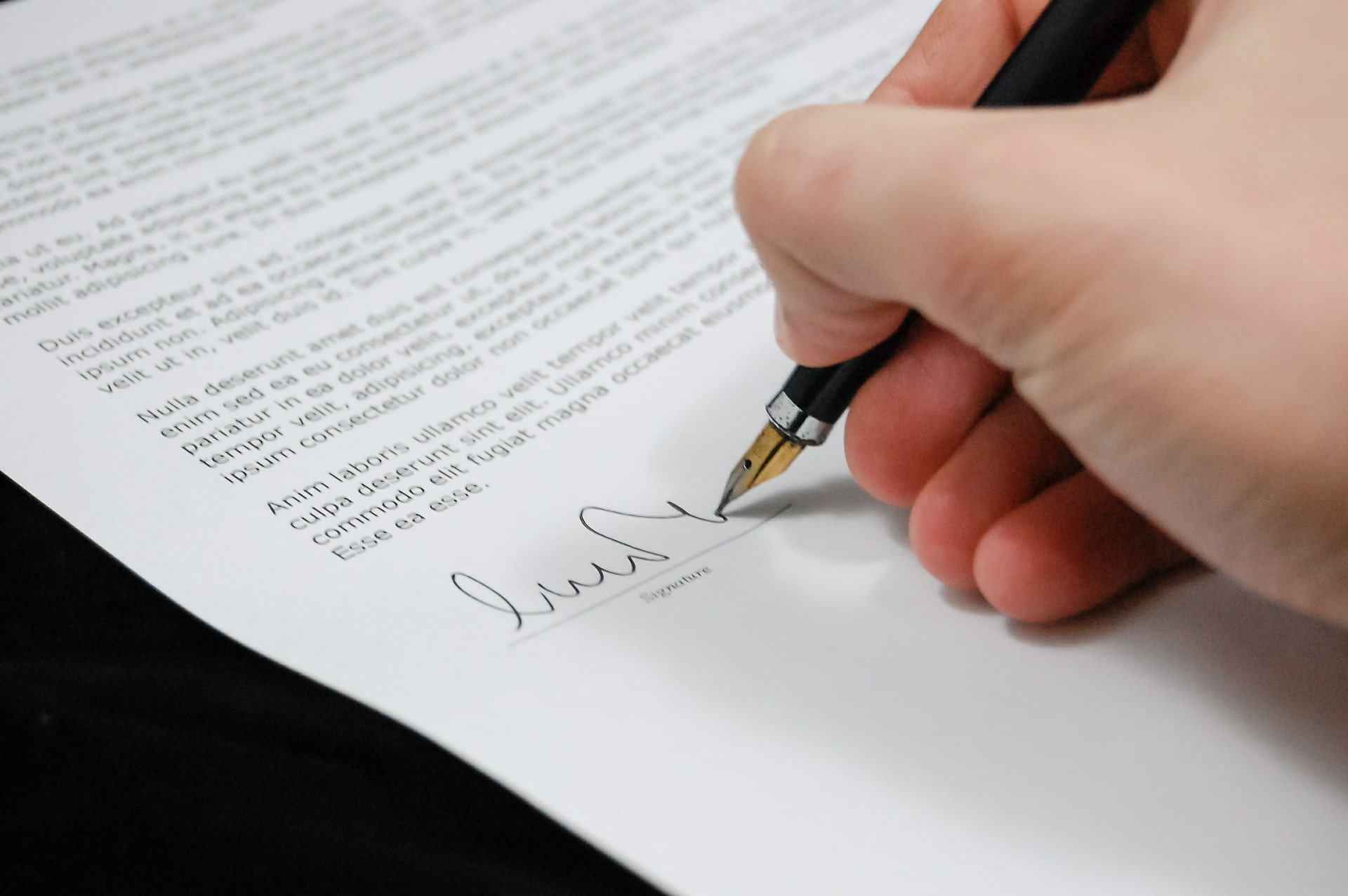 Signing Legal Document with Pen