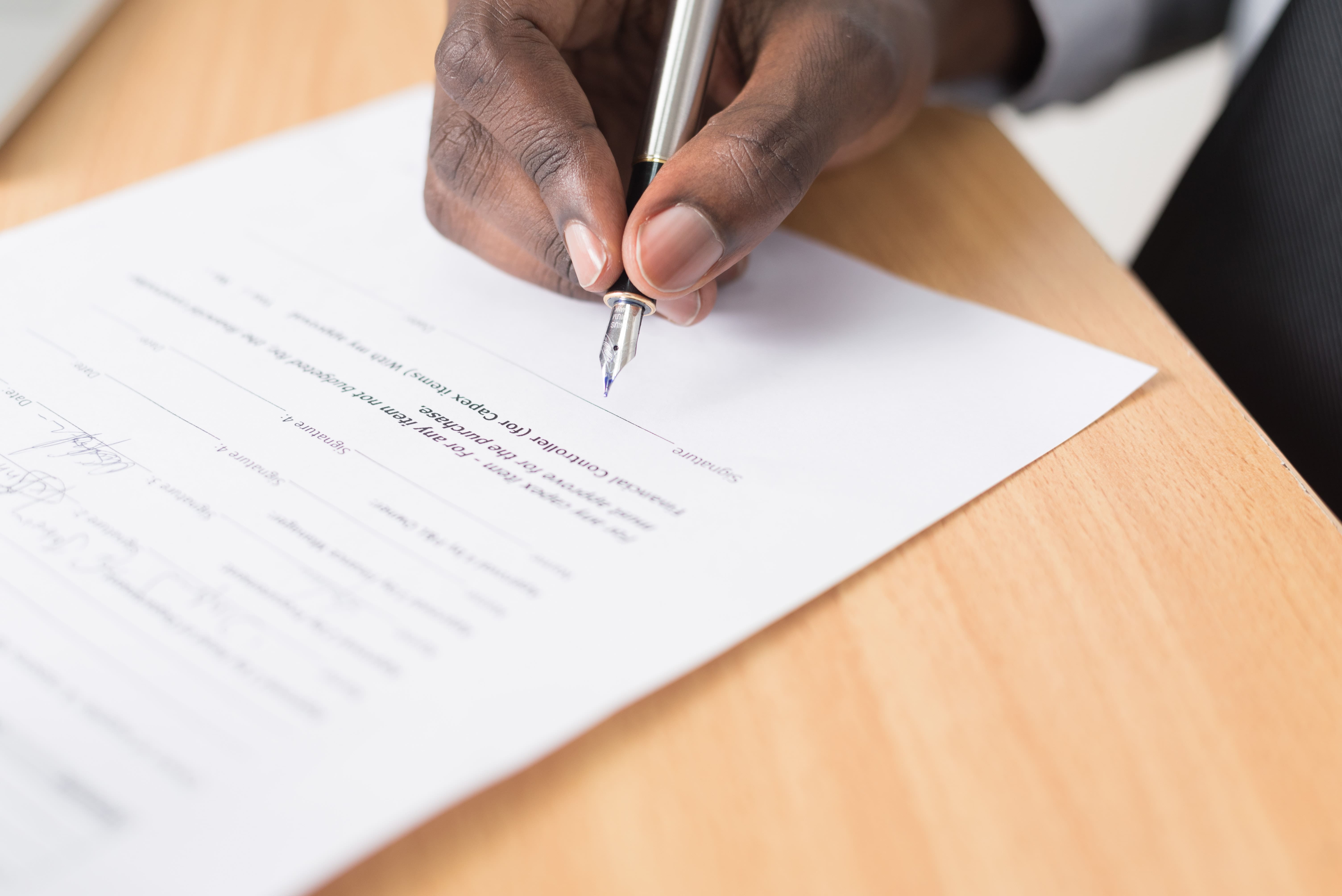 Image of Hand Signing a Document